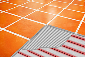 Radiant floor heating system with cutaway showing heat cable and mortar.