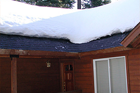 Roof de-icing system installed under shingles at roof edge. Roof de-icing system installed along roof edges.